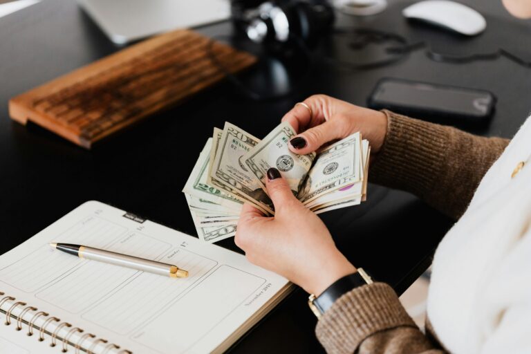 Payroll manager counting money as part of payroll management process