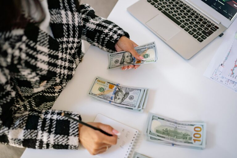Business owner reviewing payroll reports with fractional payroll support expert, ensuring accurate payroll management and compliance